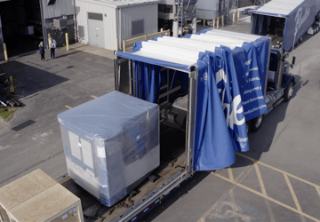 Transporting heavy machinery on retractable rollback trailer