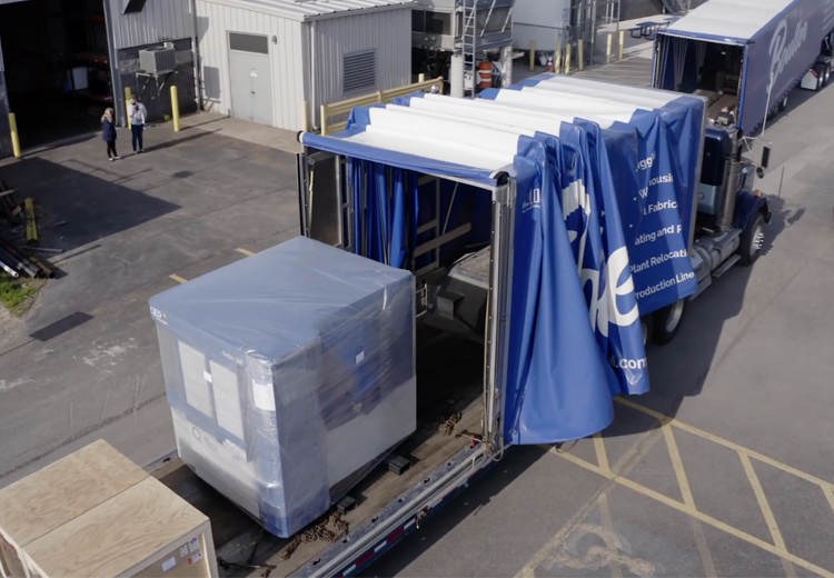 Transporting heavy machinery on retractable rollback trailer