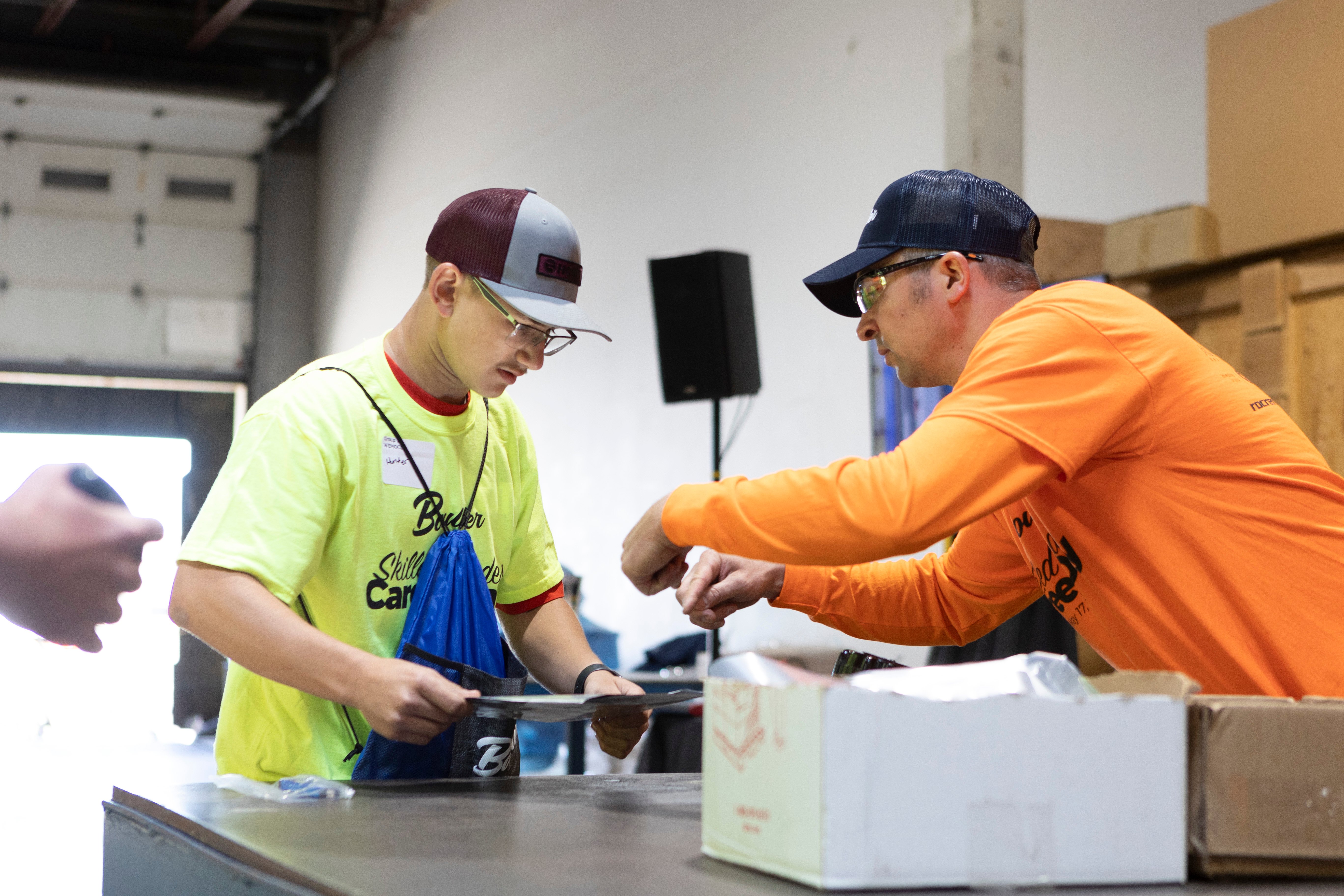 Boulter employee helping high school student during skilled trades career event