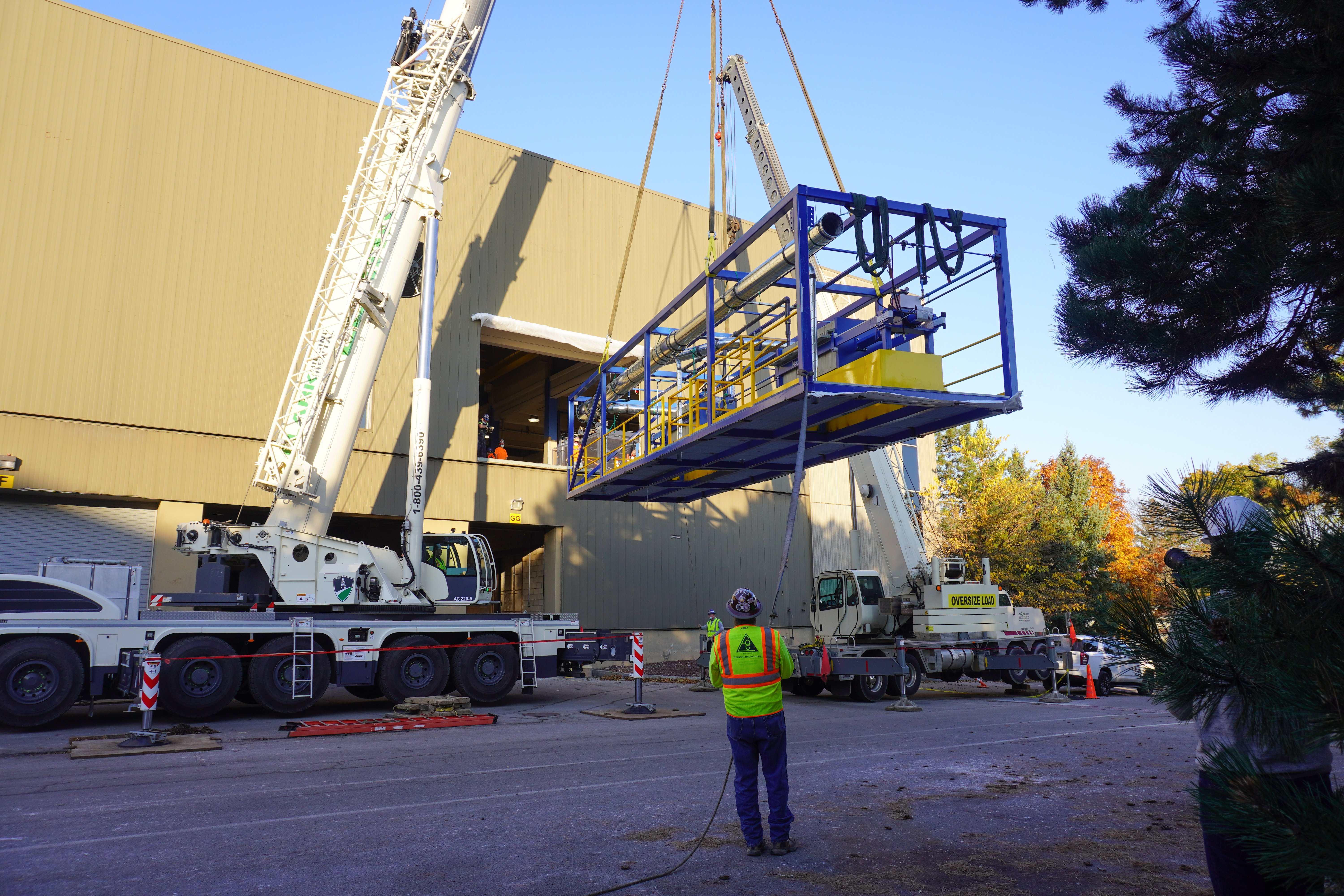 Cranes guiding skids into Li-Cycle's Rochester Spoke facility