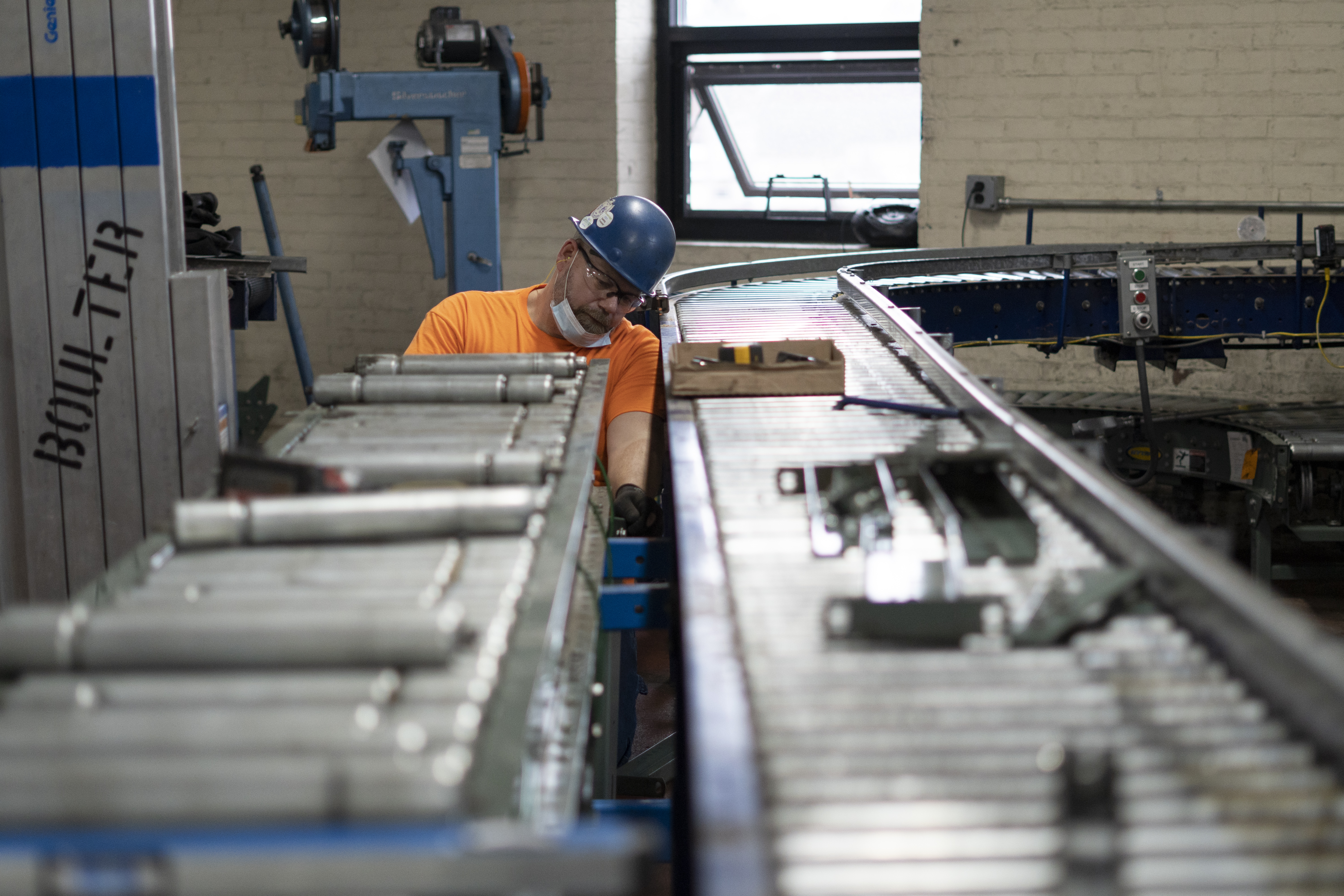 Millwright installing a second canning line for F.X. Matt Brewing