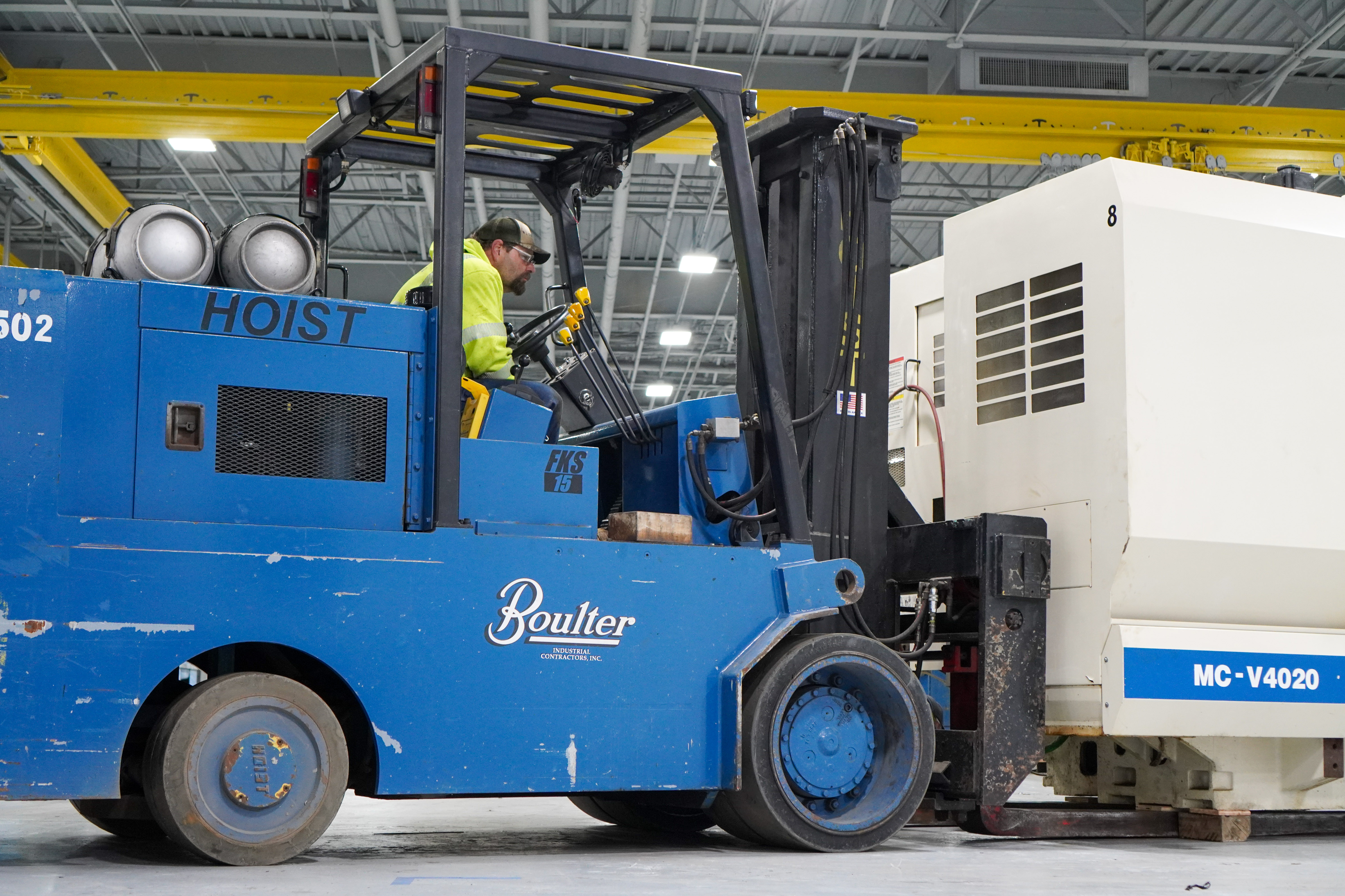 Fork Truck Setting CNC Machine into Place on Production Floor