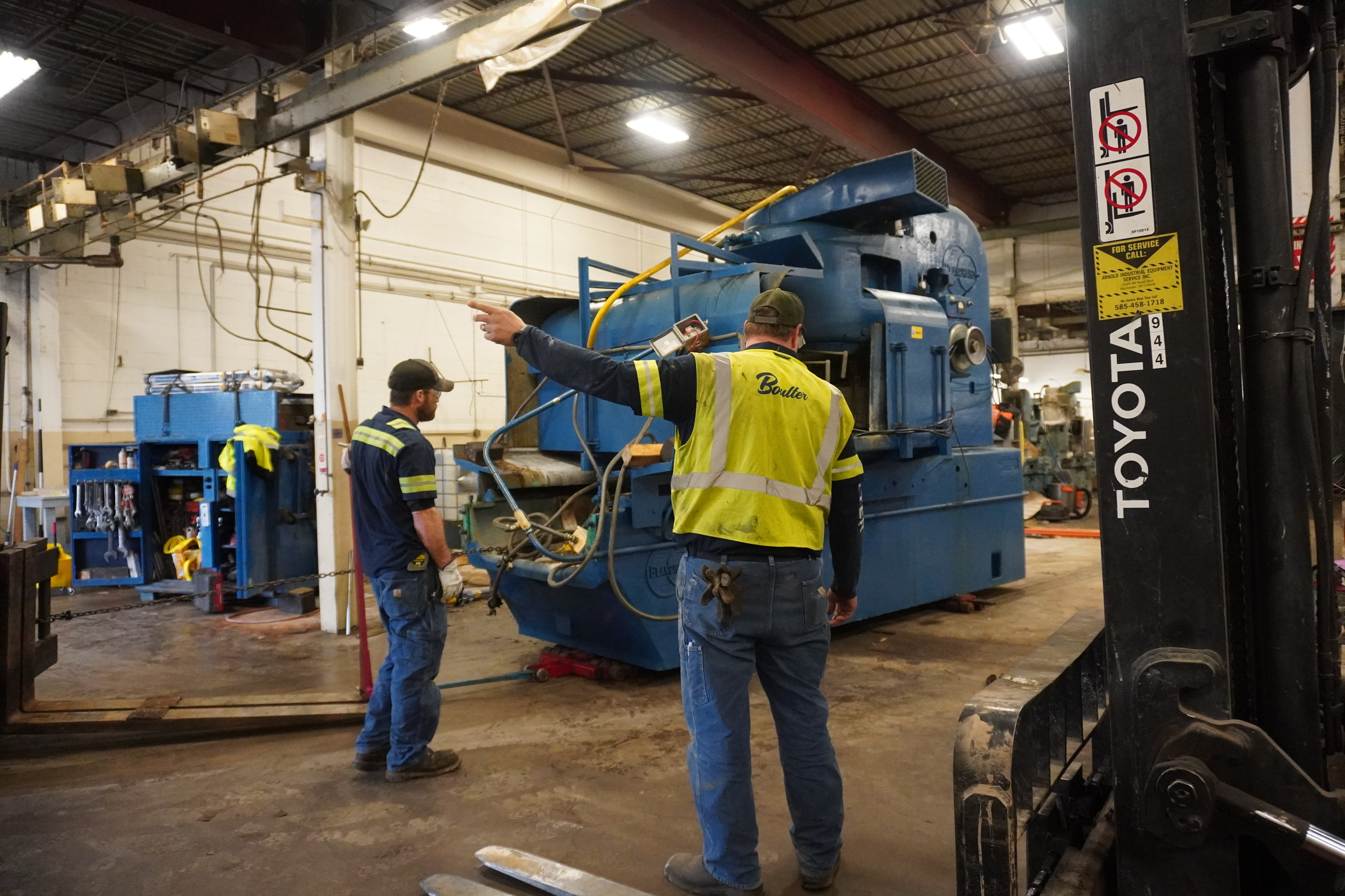 Field Technician Hand Signaling the Removal of Grinding Machine